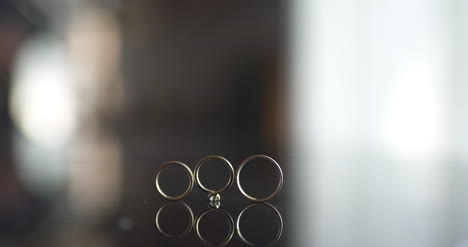 Close-Up-Of-Wedding-Rings-On-Table-2