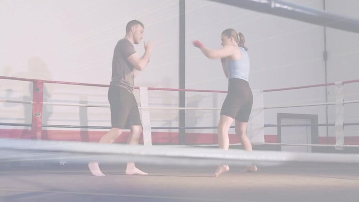 Male coach cueing female trainee throwing jabs in boxing ring, animated range lines guiding timing