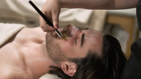 man getting his eyebrows waxed