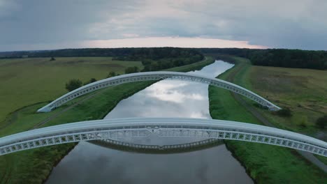 flying above gas pipes running across calm river morava in slovakia