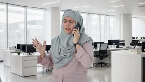 angry muslim businesswoman shouting on phone