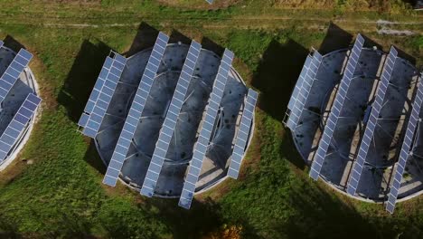 solar panels arranged in circular and rectangular structures in rural greece, bird's eye aerial