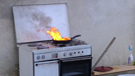 pan with fat on fire in kitchen