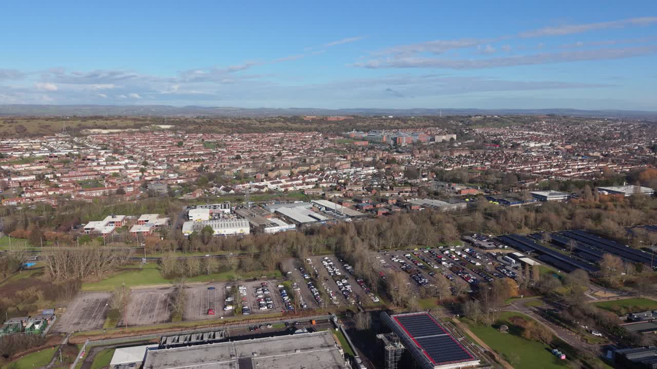 Filmato aereo con drone di Portsmouth da lontano che rivela l'area intorno all'Ospedale Queen Alexandra con viste panoramiche della campagna distante che mostrano un ambiente urbano misto in una giornata di sole splendente