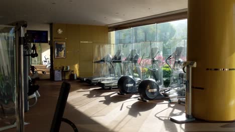 private estate gym with pandemic dividers between equipment, social distancing safety measures