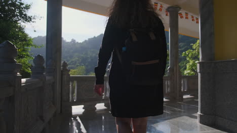 woman walking through a temple in asia