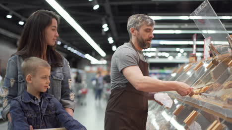 family shopping for bread at a grocery store