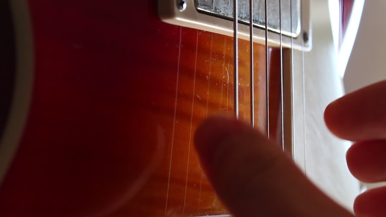 Fingerpicking nothing else matters on a cherry sunburst Les Paul guitar