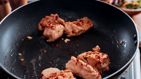 pieces of meat being fried in a pan