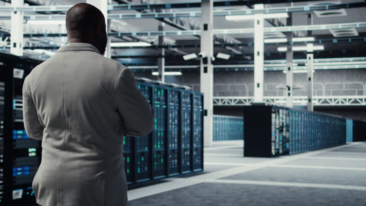 Vertical video Engineer walking in data center using device to configure hardware