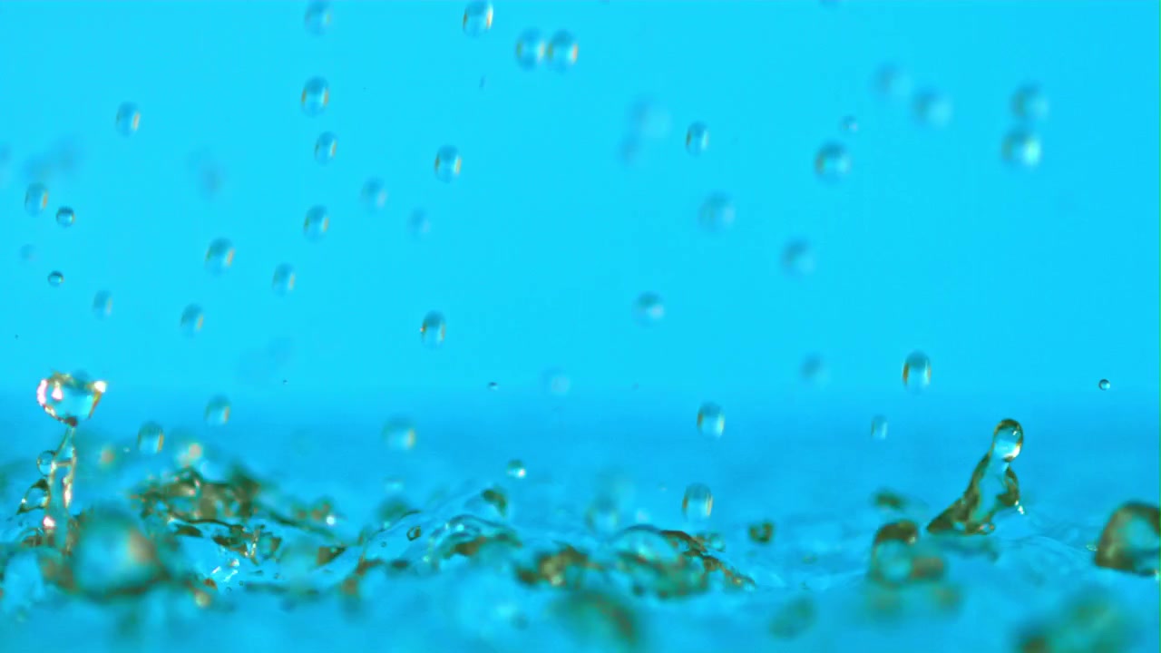 Fresh Water Droplets Splashing on a Vibrant Blue Surface