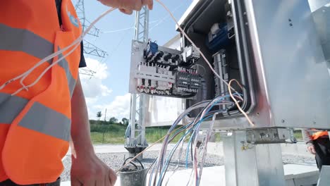 electrical engineers inspect the electrical systems at the equipment control cabinet