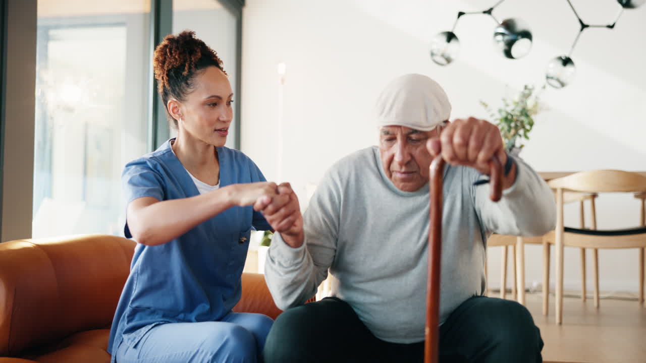 Caregiver assisting elderly man with walking