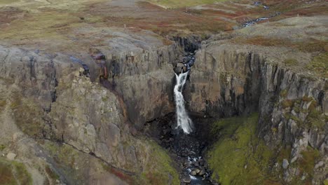 aerial view of fardagafoss waterfall during autumn in egilsstadir, iceland