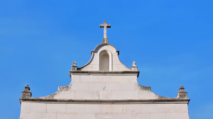 Cruz de Igreja Branca Contra o Céu Azul, Fachada Barroca Colonial Iluminada pelo Sol Com Estuque Liso, Frontão Ornamentado