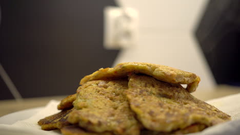 Putting-freshly-baked-homemade-vegan-pancakes-on-the-plate-with-a-black-plastic-spoon