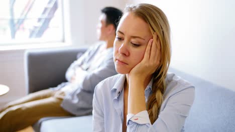 Man-and-woman-upset-with-each-other-in-living-room