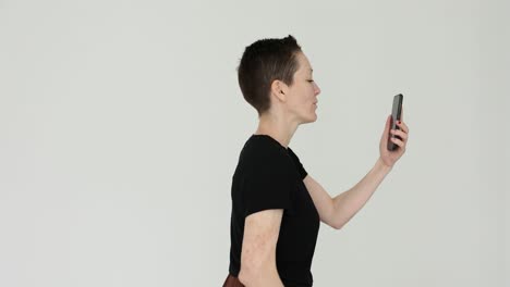 woman making a video call on her smartphone, waving and talking