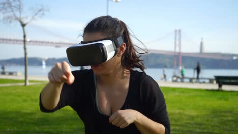 girl in virtual reality headset boxing outdoor