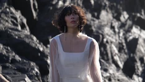 Front-Portrait-Of-A-Woman-In-White-Organza-Sheer-Top-Posing-In-Sunlight-At-The-Beach