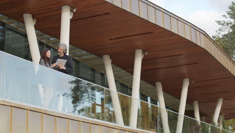 business professionals discussing on a modern building balcony