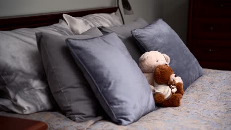 teddy bears on the double, grey bed