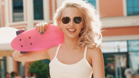 stylish woman with pink skateboard