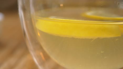 closeup of a glass of lemonade with lemon slices