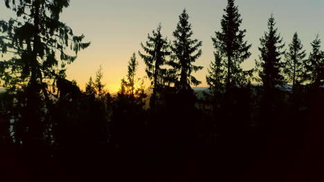 High-angle-shot-over-mountain-range-with-river-flowing-through-the-range-at-sunset-during-evening-time