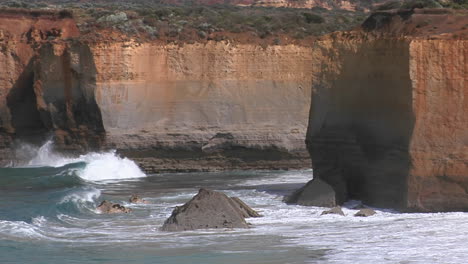 waves crash on a rugged coastline in australia