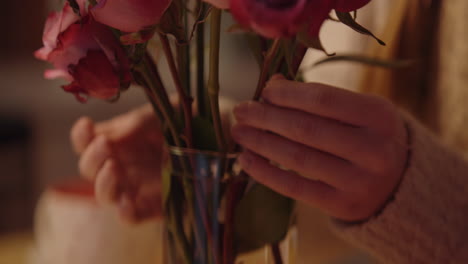 woman arranging a bouquet of roses