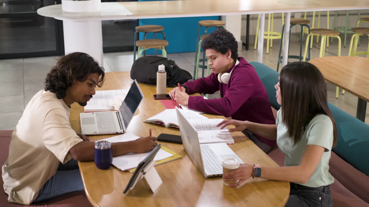 African American students checking laptops typing taking notes at study lounge studying for class
