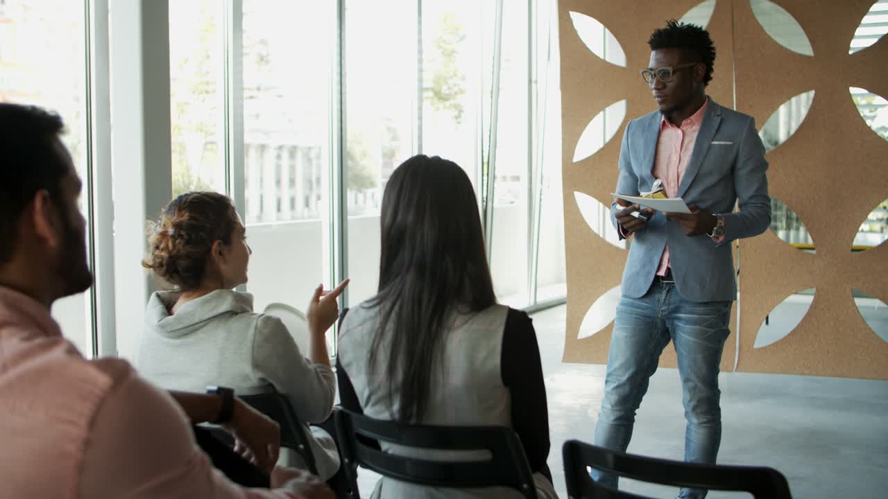 Focused consultant responding questions from audience