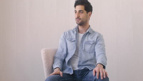 handsome man sitting on a chair 1