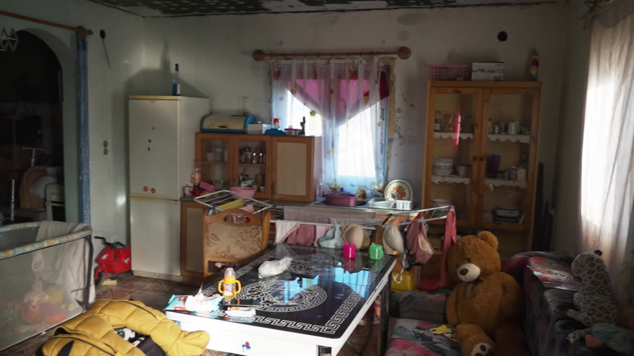 Messy living room with toys and laundry