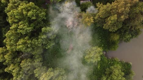 top-down footage of smoke over the amazon river and amazon rainforest, amazon fire