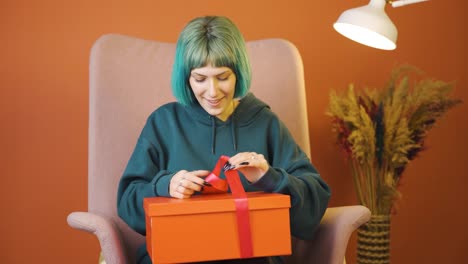 happy and joyful young woman opening gift package.