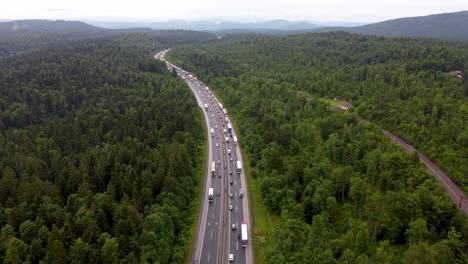 heavy traffic starting to congest the road in a countryside with cars rvs and trucks in summer time