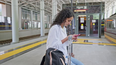 young woman waiting at train station