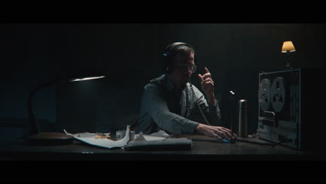 an intelligence officer takes notes at the wiretap station