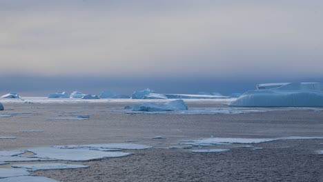 icebergs, sea ice and ocean in antarctica