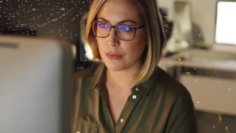 Woman working on a computer at night