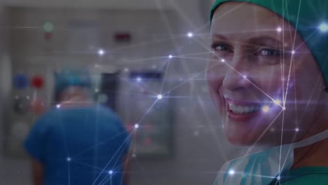 Animation-of-network-of-connections-over-happy-caucasian-female-surgeon-looking-at-camera