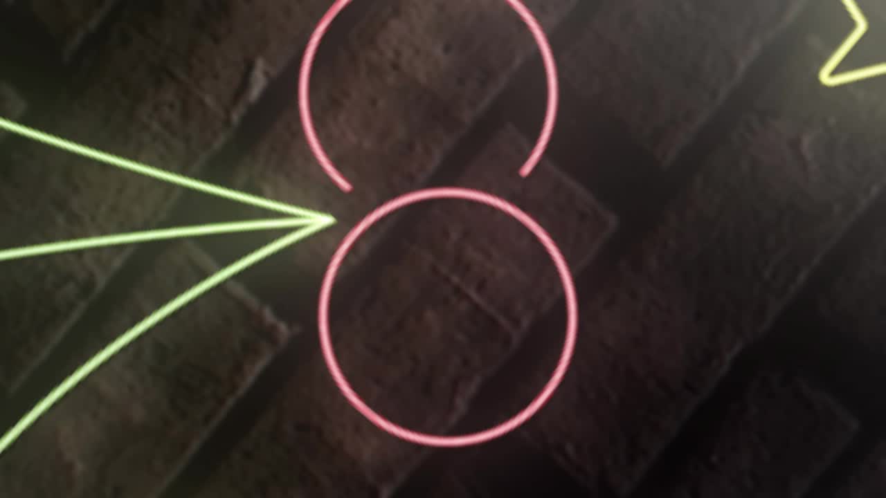 White circle drifting causing bokeh lights floating over neon holly Xmas sign for festive decor