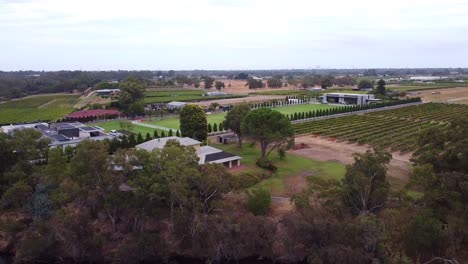 panning shot right to left of an equestrian centre, buildings and a river