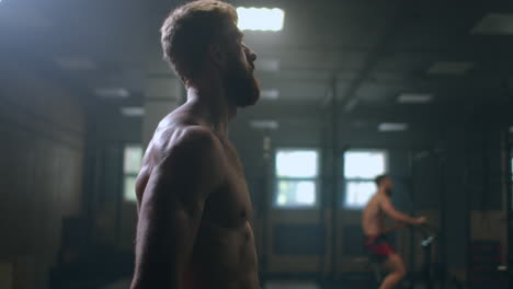 haggard tired man in the gym sweaty after a workout relax and take deep breaths