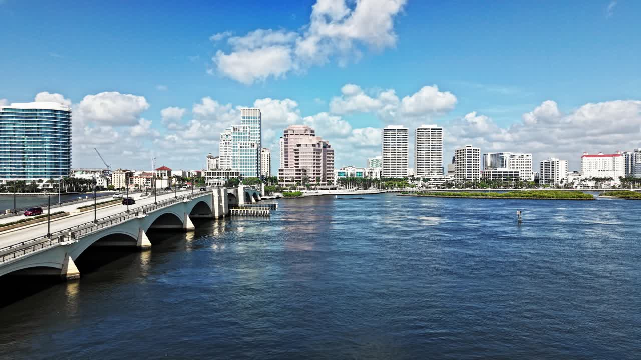 Aerial: cityscape with Royal Park Bridge, One Flagler and Phillips Point building during the day in West Palm Beach, Florida, USA, pan drone shot