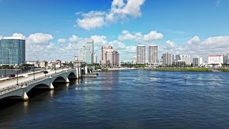 aerial: cityscape with royal park bridge, one flagler and phillips point building during the day in west palm beach, florida, usa, pan drone shot