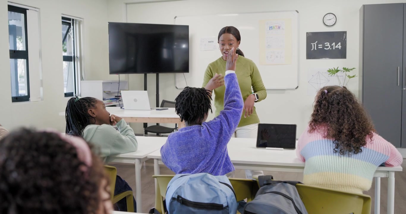 African American teacher with six girls responding to hand raise, explaining pi on classroom board