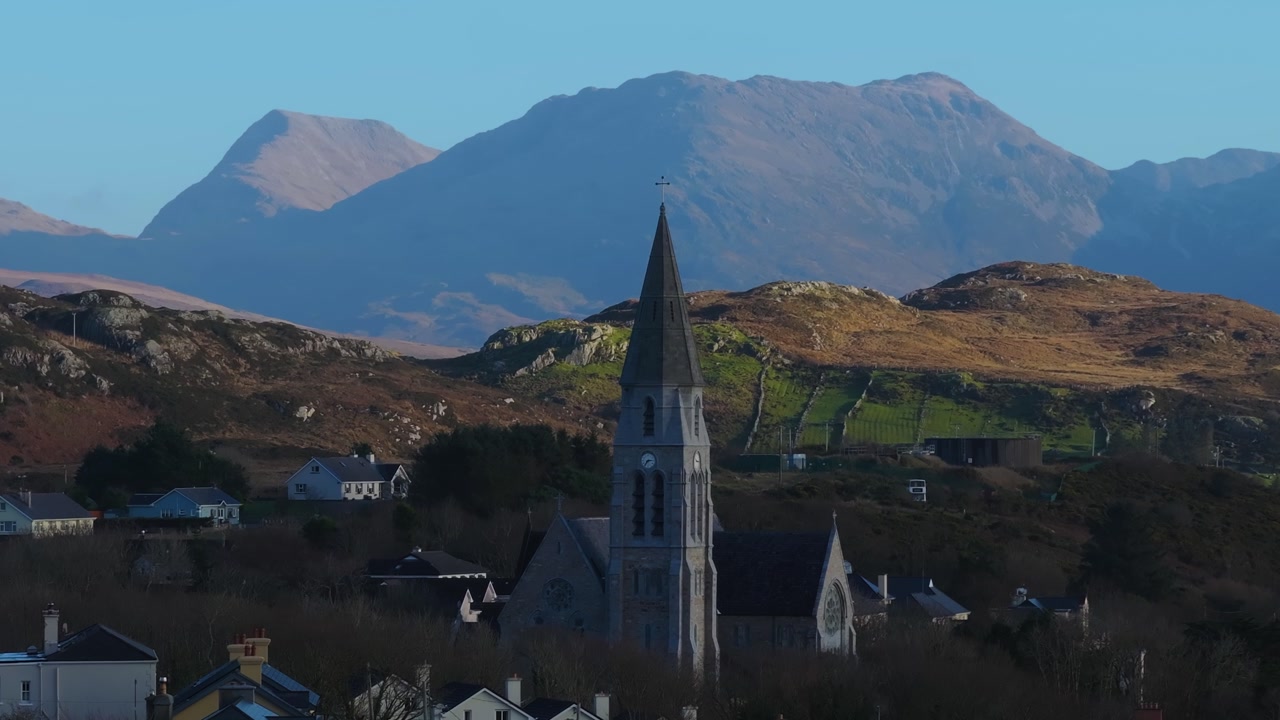 4K Aerial drone footage of St Joseph’s Church in Clifden, Galway with Connemara Mountains Background_003